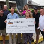 Check presentation to Food 4 Kidz from a Bay Helping Bay event