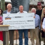 Check presentation to St. Andrews Community Medial Center from a Bay Helping Bay event