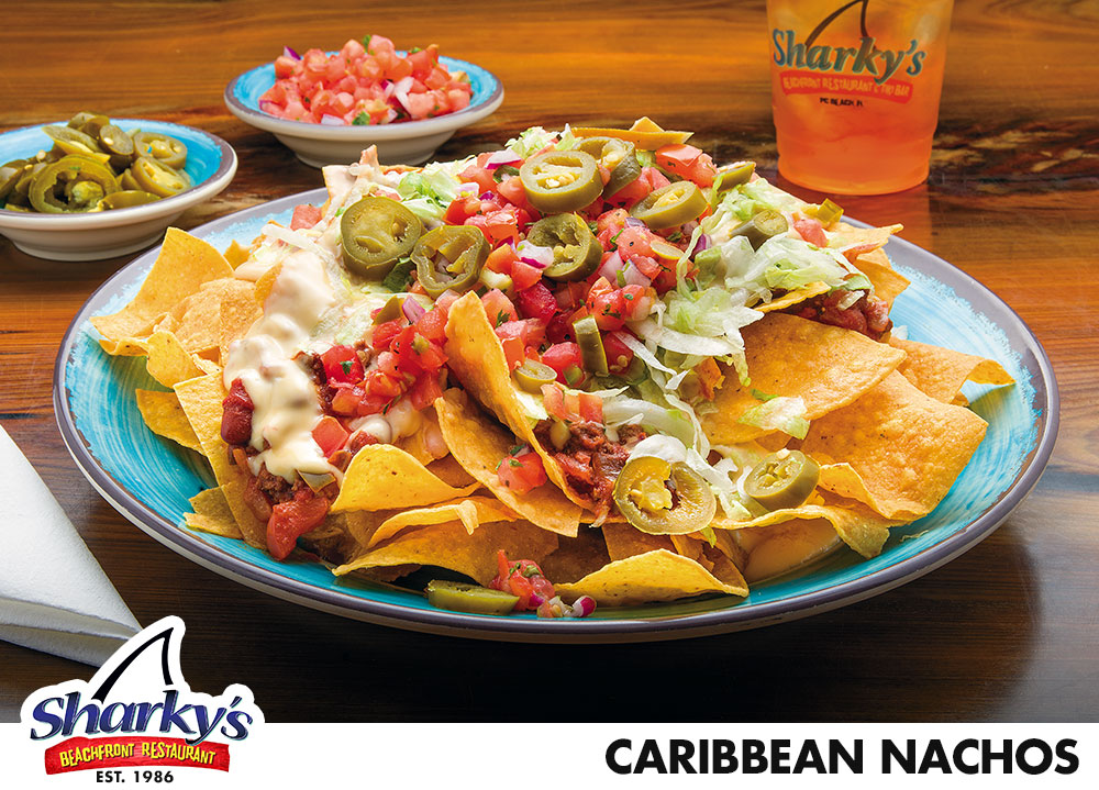Caribbean Nachos has tortilla chips with chili, Monterey Jack cheese sauce, shredded lettuce & pico de gallo. Sour cream & jalepenos on the side