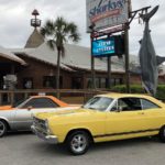 2 classic cars in front of Sharky's for Emerald Coast Cruizin'