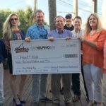 Check presentation to Food 4 Kidz from a Bay Helping Bay event