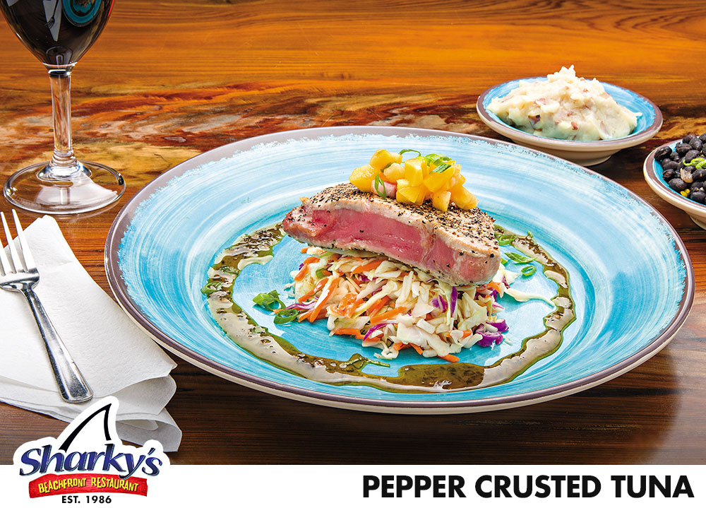 Black Pepper crusted Yellowfin Tuna steak cooked to temp served over Asian Slaw topped with Pineapple Mango Salsa, drizzled with Honey Soy glaze