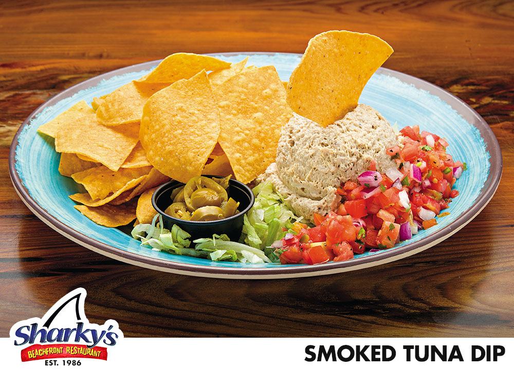 Smoked Tuna Dip is made with fresh smoked tuna dip over shredded lettuce with pico de gallo & jalapeños. Served with tortilla chips
