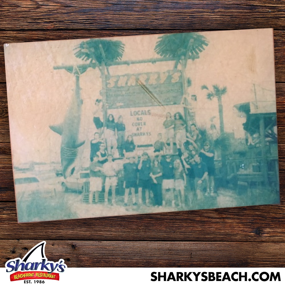 Sharky's opening team in front of the original Sharky's sign