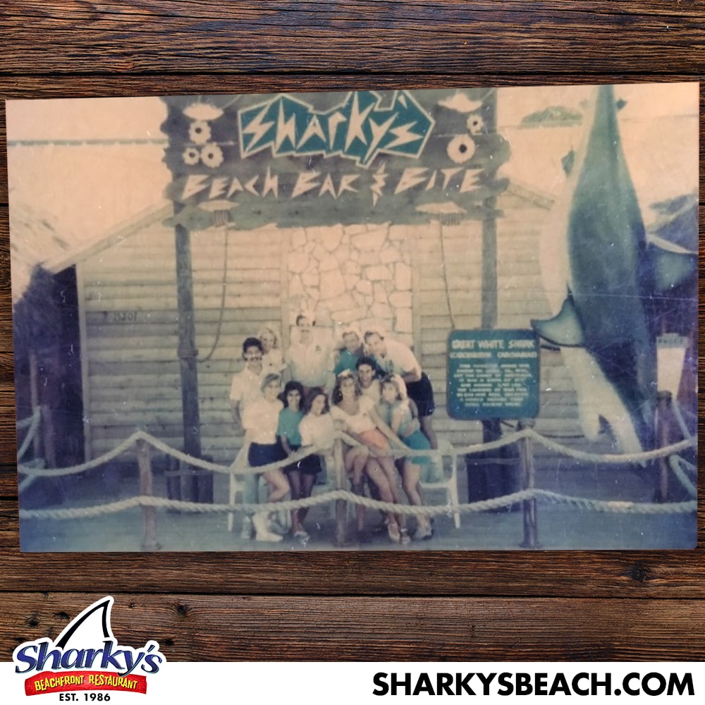 Staff in front of a old Sharky's sign
