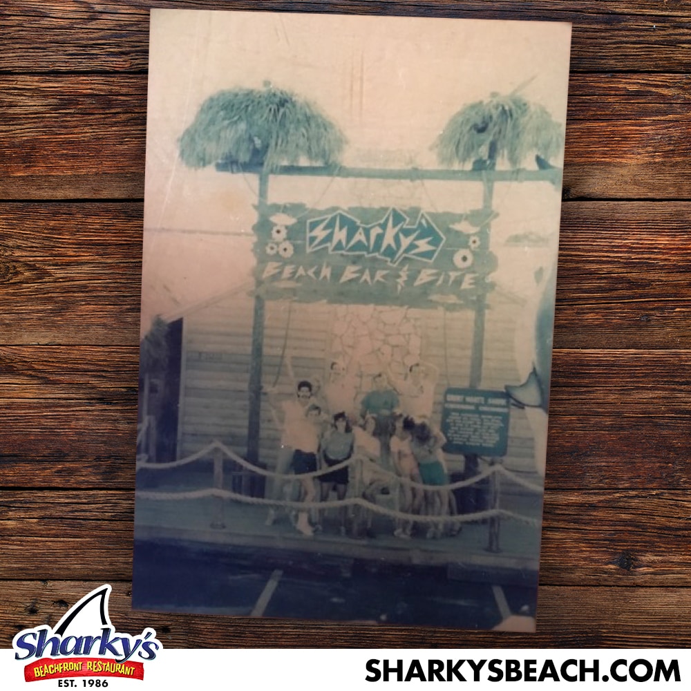 Staff in front of a old Sharky's sign