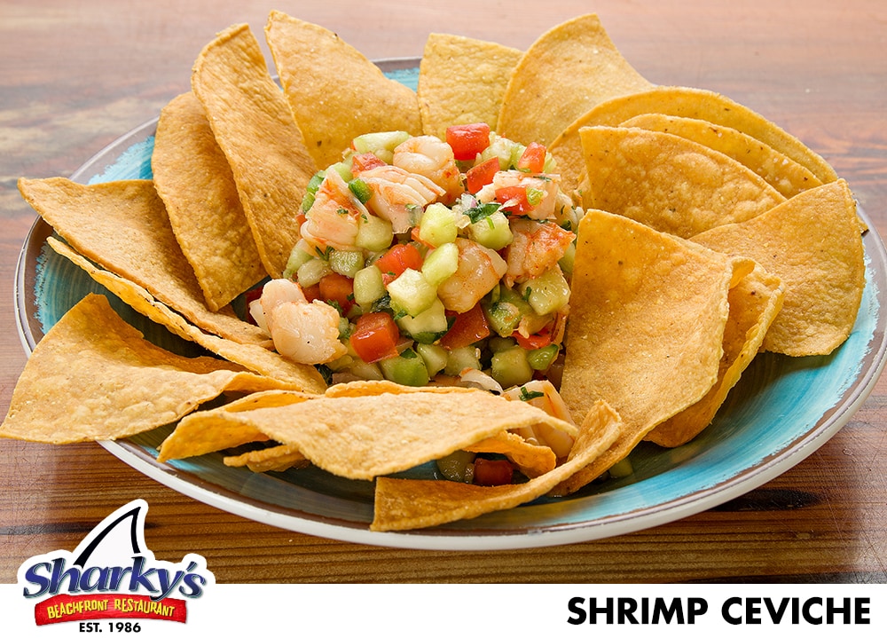 Shrimp Ceviche made with Shrimp marinated in Lime juice with diced tomatoes, cilantro, cucumbers, onions, jalapenos, salt and pepper (This appetizer is served cold). Served with Tortilla Chips
