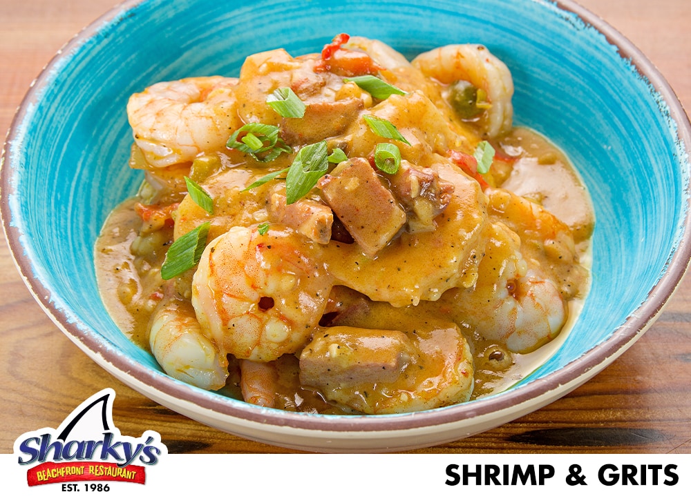 Shrimp & Grits made with A scoop of Triple Cheese Grits topped with sautéed Jumbo Shrimp with peppers, onions & Tasso Gravy